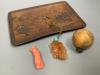 A Chinese carved hardstone pendant, a carved coral Guanyin, an engraved nut pendant, and a lacquered tray                                                                                                                   