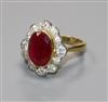 A modern 18ct gold, ruby and diamond oval cluster ring, size N.                                                                        