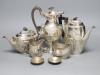 A George V demi fluted silver four piece tea and coffee service, Mappin & Webb, Sheffield, 1912, a matched plated hot water pot and two small 925 dishes                                                                    