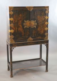 A late 17th century japanned cabinet on later stand W. 3ft. 1in. D. 1ft 4.5in. H. 2ft. 6in. Height overall 6ft 3in.                    