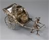 A late 19th/early 20th century Chinese white metal condiment stand by Luen Wo?, modelled as a rickshaw, length 19cm.                   