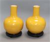 A pair of yellow ground bottle vases, on hardwood stands Height excluding stands 25cm                                                  