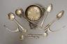 Small silver including two pairs of silver wishbone sugar nips, Levi & Salaman, Birmingham, 1922, a silver tea strainer and assorted spoons.                                                                                