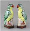 A pair of Chinese porcelain models of parrots, Qianlong/Jiaqing period, 18cm high, wood stands                                         