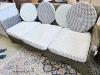 A contemporary all weather rattan three seater sofa and cushions. W-200cm, D-74cm, H-83cm.                                                                                                                                  