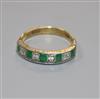 A modern 18ct gold, emerald and diamond nine stone half hoop ring, size N.                                                             