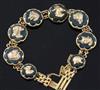 An early 20th century 9ct gold and bloodstone panel set bracelet, each stone with a gold dog's head applique, gross 19 grams.          