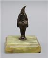 A small bronze pierrot, on green onyx base                                                                                             