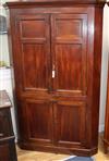 An early 19th century mahogany panelled standing corner cupboard H.180cm                                                               