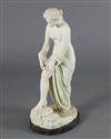 A Victorian style carved white marble figure of a woman pulling on her stocking, H.31in.                                               