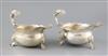 A pair of Victorian silver sauceboats with flying scroll dolphin head handles, London, 1883, 30.5oz.                                   