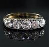 A Victorian style gold and graduated five stone diamond half hoop ring, size M.                                                        