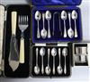 Two cased sets of six silver teaspoons, one with tongs, a cased set of silver fish servers and cased pair of silver napkin rings.      