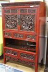 A Chinese red lacquered carved hardwood cupboard W.104cm                                                                               