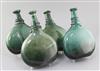 Four Persian green glass saddle flasks, 18th/19th century, 23cm - 25.5cm                                                               