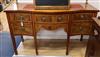 An Edwardian satinwood serpentine fronted mahogany sideboard, with tubular brass railed back W.152cm                                   