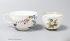 A Meissen bowl, c.1750, moulded and painted with flowers, 6cm diameter and Meissen cup, c.1750 painted with a parrot and flowers (2)                                                                                        