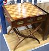 A Waterloo chess set by Charles Stadden, No. 27/250, in military style brass-bound mahogany games table on folding stand               