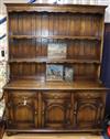 A reproduction oak dresser, with boarded plate rack W.154cm                                                                            