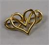 An 18ct gold scrolling heart brooch, with metal pin, 31mm.                                                                             
