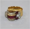 A 1950's? yellow metal, ruby and diamond cocktail ring, size I.                                                                        