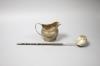 A George III silver cream jug, London, 1802 (a.f.)9.5cm and a 19th century white metal toddy ladle, 35cm.                                                                                                                   