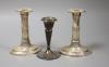 A pair of late Victorian silver dwarf candlesticks, George Howson, Sheffield, 1900, 15.2cm and one other silver candlestick, all weighted.                                                                                  