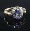 A Georgian yellow metal ring set oval sapphire in scrolled mount between seated lion shoulders, size T.                                