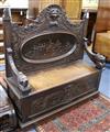 A 19th century carved oak settle W.123cm                                                                                               