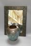 An Arts and Crafts planished copper mirror and a WMF Ikora vase                                                                                                                                                             