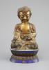 A Chinese copper alloy and enamel seated figure of Buddha Shakyamuni, Qing dynasty, 24cm high, faults                                                                                                                       