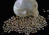 A quantity of loose undrilled (untested) pearls of varying shapes, colours and sizes and a pearl in half shell,                        