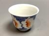 A Chinese underglaze blue and iron red 'bat' cup, height 6cm                                                                                                                                                                