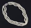 A triple strand cultured pearl choker necklace with 9ct white gold and diamond cluster clasp, 41cm.                                    