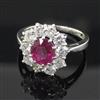 A white gold, ruby and diamond cluster ring, size O.                                                                                   