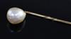 An oval button shaped natural saltwater pearl set stick pin, with Gem & Pearl Laboratory report date 13/5/2016, overall 56mm.          