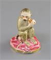 A Rockingham porcelain figure of a seated monkey, c.1830, H. 7.1cm, repaired                                                           