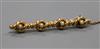 A yellow metal and seed pearl set spiral bar brooch, 45mm.                                                                             