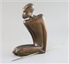 A Hagenauer hardwood figure of a kneeling native man holding a brass spear, height 10.5in.                                             