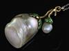 A gold and green enamel mounted natural saltwater oval and large baroque pearl pendant, on a platinum fine link chain.                 