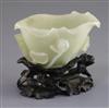 A Chinese pale celadon jade 'lotus' brushwasher, 18th/19th century, L. 9.7cm, carved wood 'lotus' stand                                