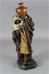 A Goldscheider style painted plaster figure of an Arab water carrier, H.40in.                                                          