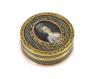 A late 18th century tortoiseshell boîte-à-miniature, the cove decorated with an inset portrait miniature of a young lady, mounted with pierced yellow metal borders 7.5cm diameter                                          