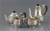 An Edwardian silver four-piece tea and coffee set, rounded body with medallion heads, scroll handles,                                  