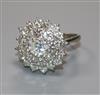 An 18ct white gold and diamond cluster ring, the central stone weighing approximately 0.90cts, size M.                                 