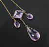 An early 20th century gold and shaped cut amethyst drop necklace, overall 52cm.                                                        