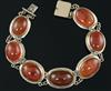 A late Victorian gold and cabochon agate set bracelet, gross 27.9 grams.                                                               