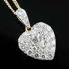 An 18ct gold and diamond encrusted heart shaped pendant with central pear shaped diamond, pendant 14mm.                                