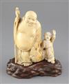 A Japanese ivory okimono of Hotei and a boy, early 20th century, height 16.5cm, wood stand                                             