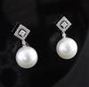 A pair of 18ct white gold and South Sea pearl drop earrings, 1in.                                                                      